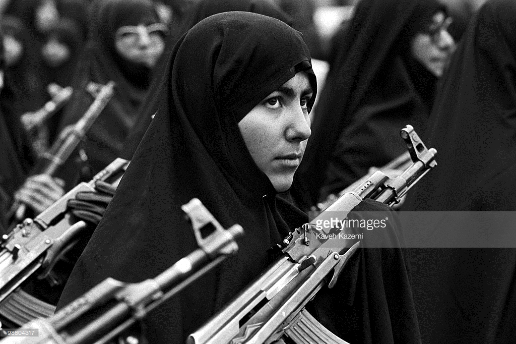 Tehran, Iran: Basiji (mobilized volunteer forces) women in black chador carry AK-47 automatic assault rifles in a Tehran rally, 29th November 1988. Towards the end of the eight year long Iran-Iraq war, Iraq was widely expected to resort to chemical weapons. (Photo by Kaveh Kazemi/Getty Images)
